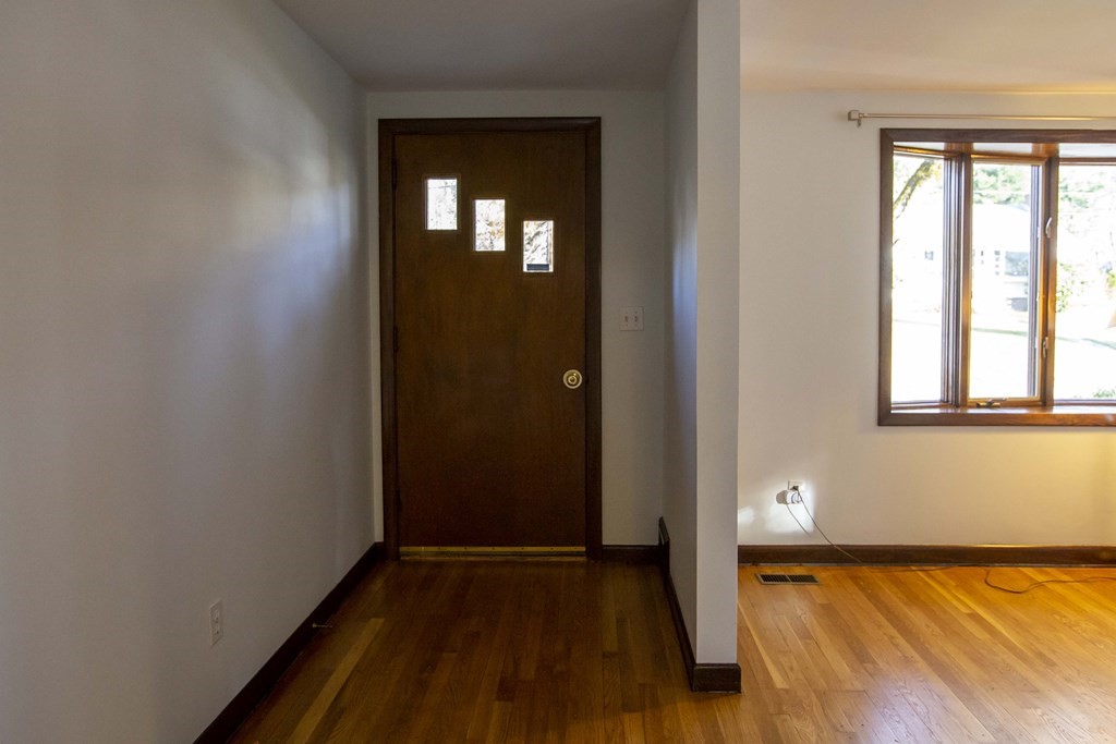 69 Sturges Road Reading, MA 01867 - Photo 2 of 42 a view of hallway with window and wooden floor