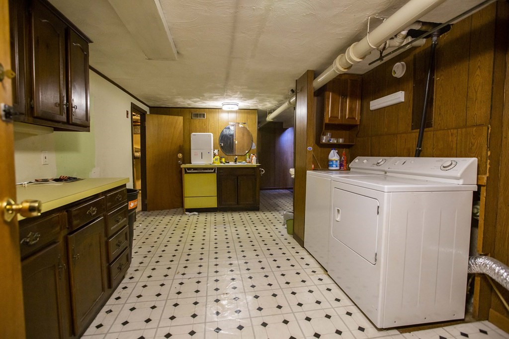 69 Sturges Road Reading, MA 01867 - Photo 26 of 42 a kitchen with a sink a stove cabinets and wooden floor