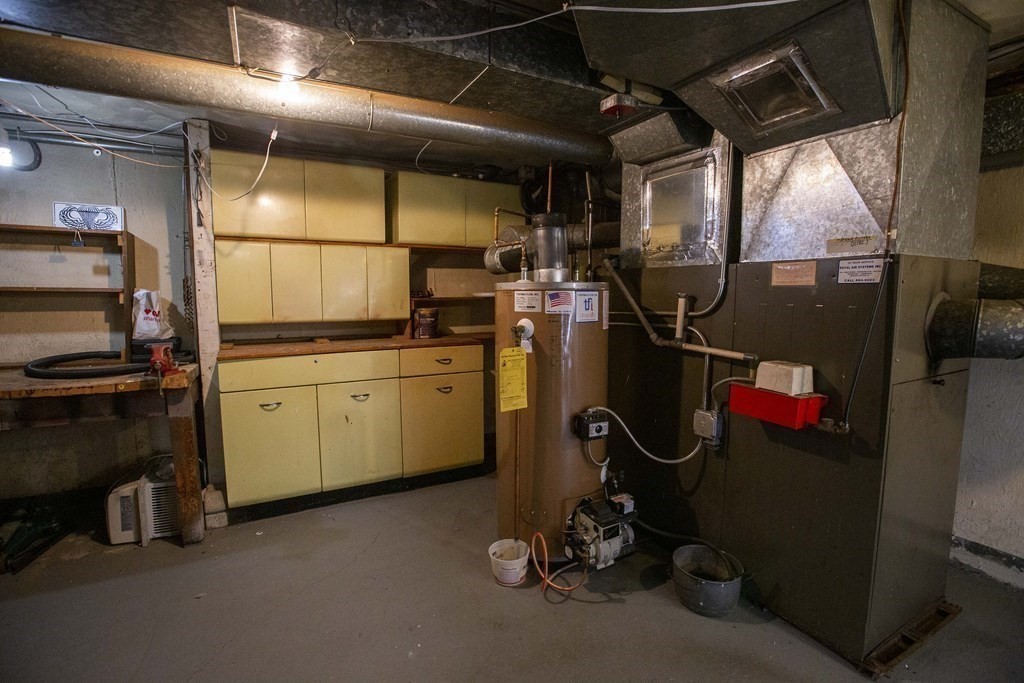 69 Sturges Road Reading, MA 01867 - Photo 27 of 42 a storage room with cabinets