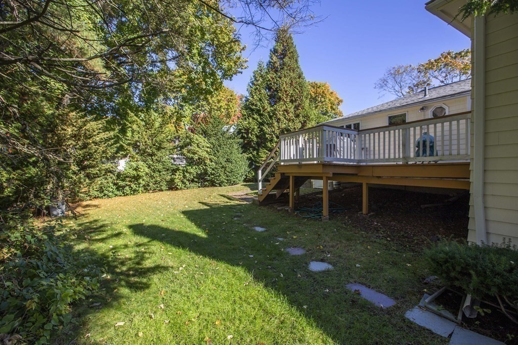 69 Sturges Road Reading, MA 01867 - Photo 35 of 42 a backyard of a house with lots of green space
