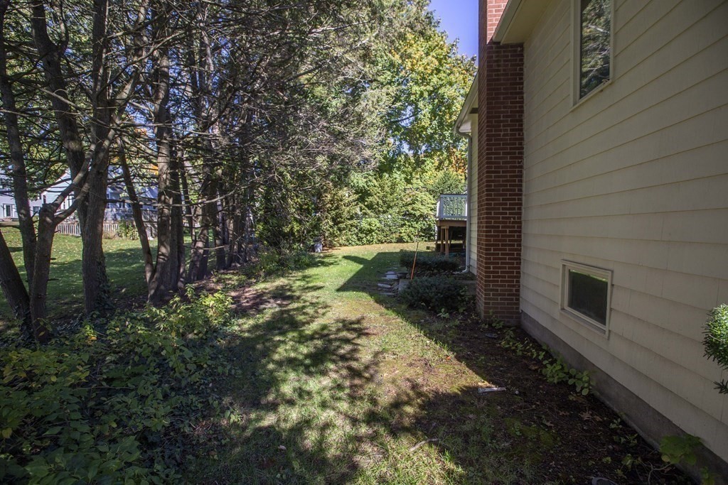 69 Sturges Road Reading, MA 01867 - Photo 36 of 42 a backyard of a house with lots of green space
