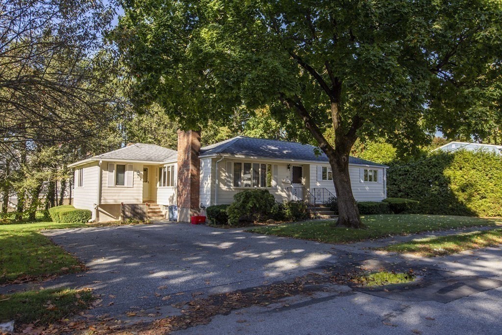 69 Sturges Road Reading, MA 01867 - Photo 37 of 42 a front view of a house with a yard and outdoor seating