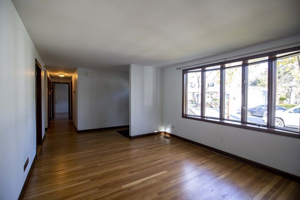 69 Sturges Road Reading, MA 01867 - Photo 5 of 42 wooden floor in an empty room with a window