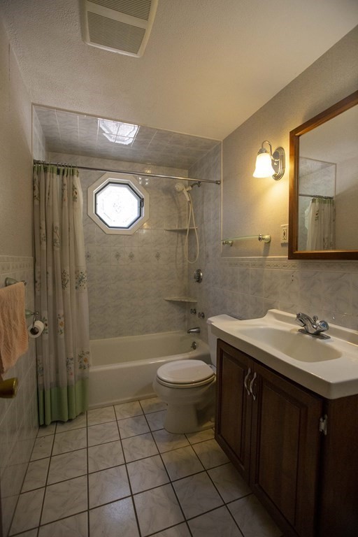 69 Sturges Road Reading, MA 01867 - Photo 6 of 42 a bathroom with a sink a toilet and shower
