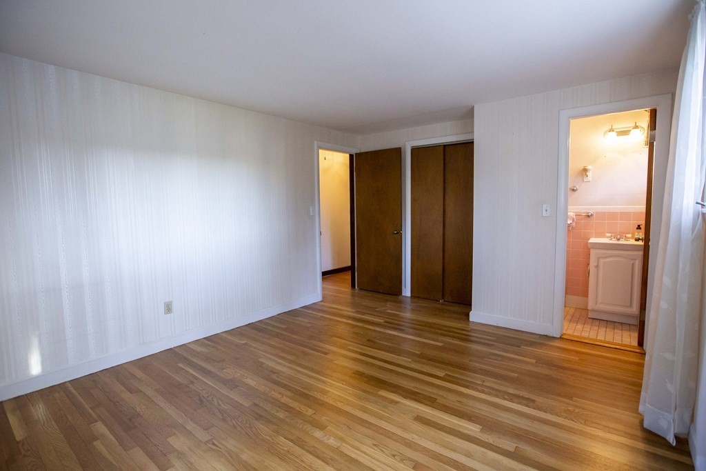 69 Sturges Road Reading, MA 01867 - Photo 8 of 42 a view of an empty room with wooden floor and a window