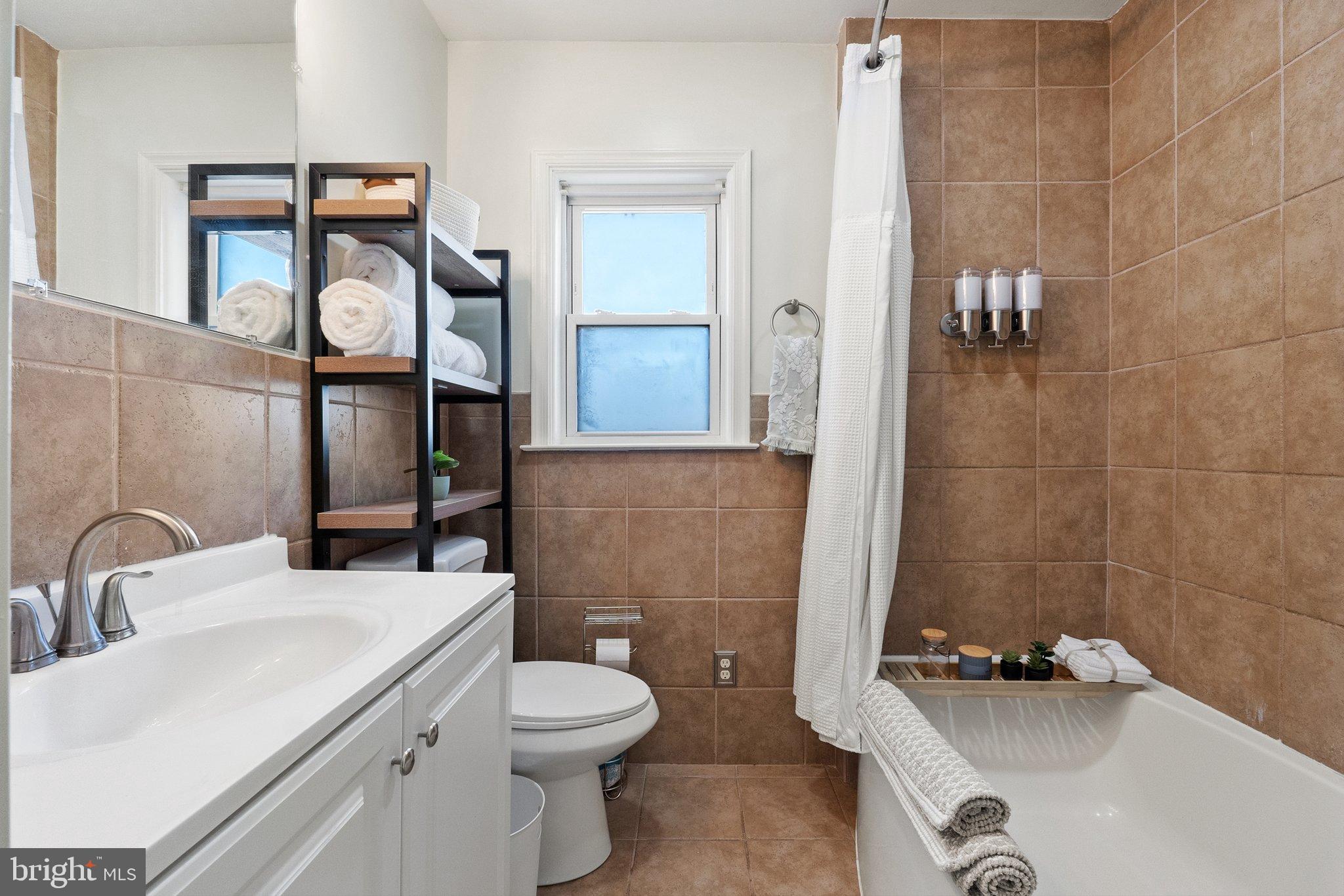701 South 2nd Street Shenandoah, VA 22849 - Photo 26 of 39 Modern bathroom with warm tile accents.