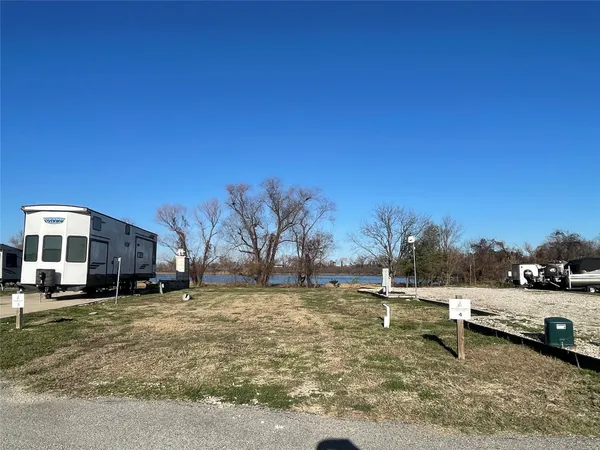 a view of a yard with car parked