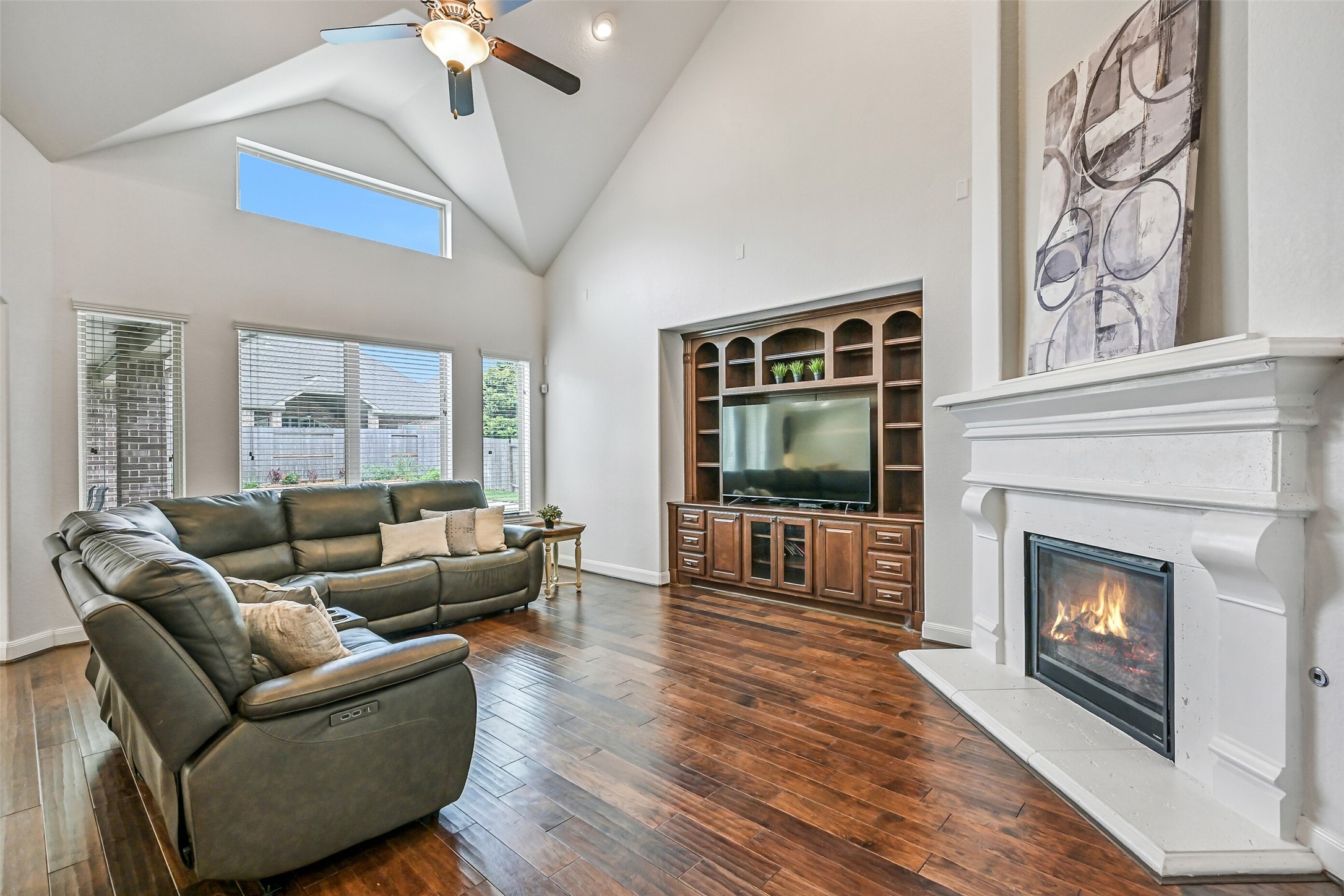 1008 Point Isabel Lane Friendswood, TX 77546 - Photo 23 of 50 Tall windows fill the room with natural light while emphasizing the height of the ceiling. The layout offers flexibility for larger seating arrangements without losing its comfortable feel.