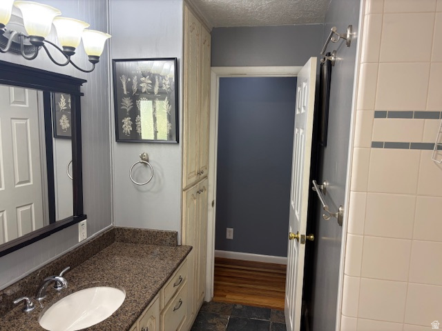 2313 150 East Bountiful, UT 84010 - Photo 19 of 39 Bathroom vanity with a polished stone countertop, undermount sink, and chrome faucet