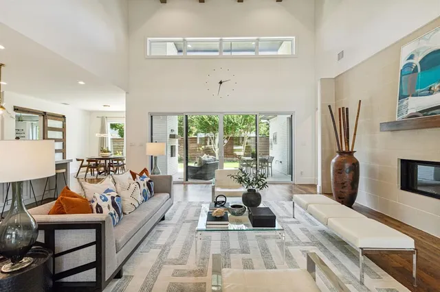 a living room with furniture fireplace and a window