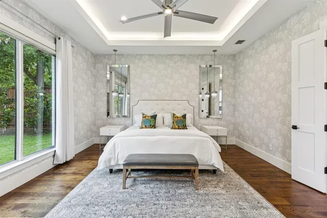 a bed room with a bed and a large window