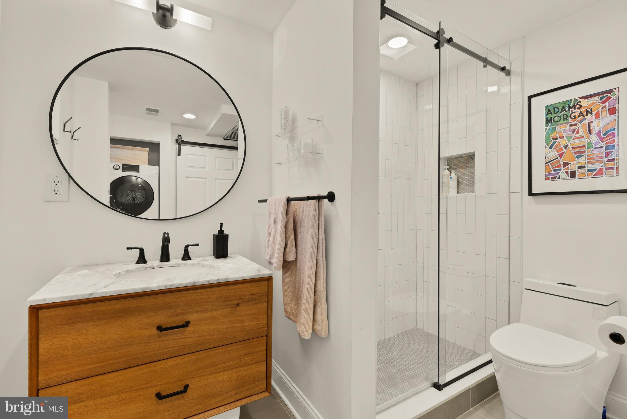 2370 Champlain Street Northwest, Unit 21 Washington, DC 20009 - Photo 15 of 22 a bathroom with a toilet a sink and a mirror