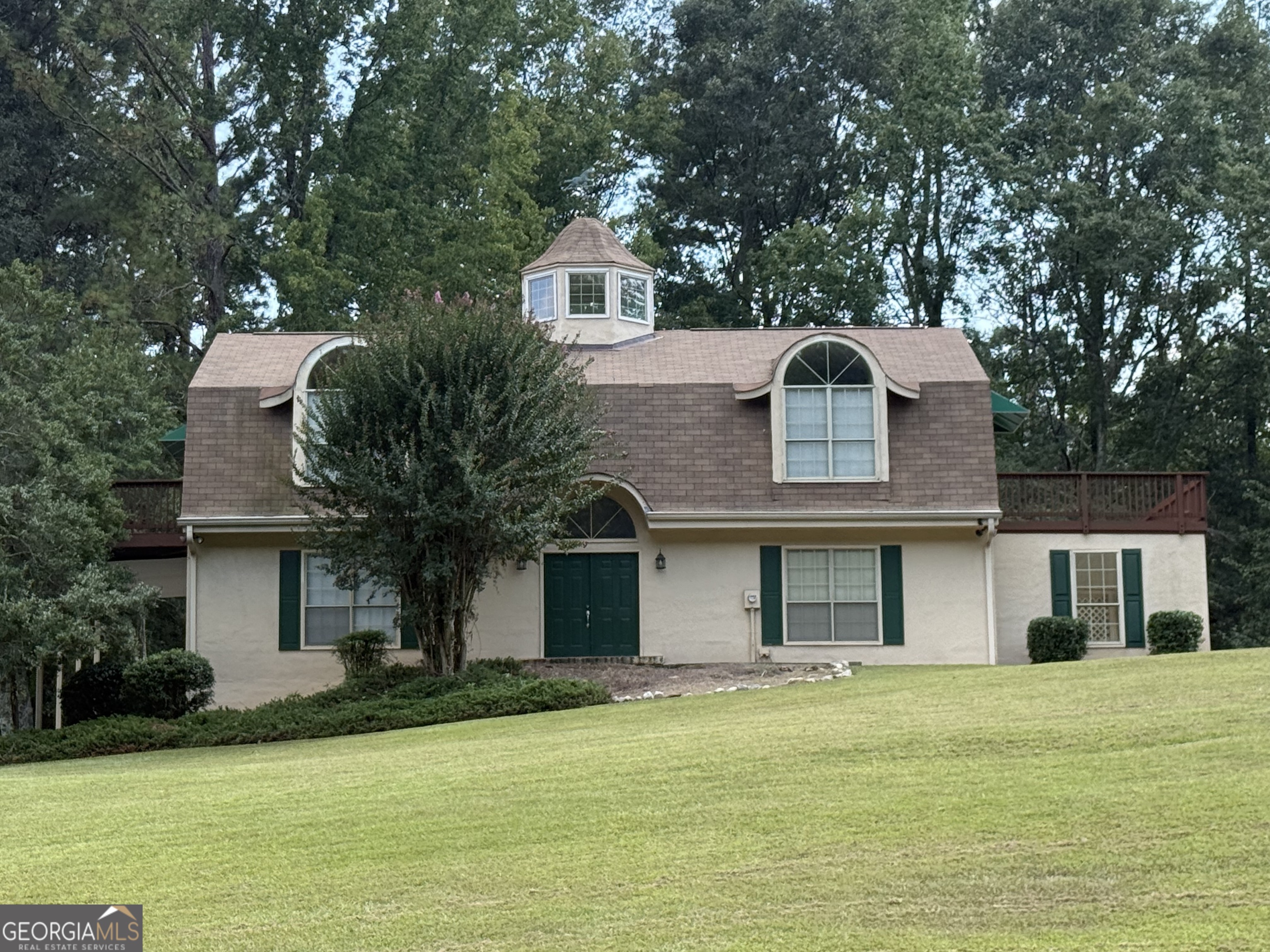 a front view of a house with a garden