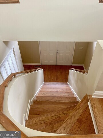 242 Ebenezer Church Road Fayetteville, GA 30215 - Photo 17 of 46 a bed sitting in a bedroom with wooden floor