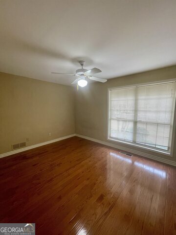 242 Ebenezer Church Road Fayetteville, GA 30215 - Photo 23 of 46 an empty room with wooden floor and windows