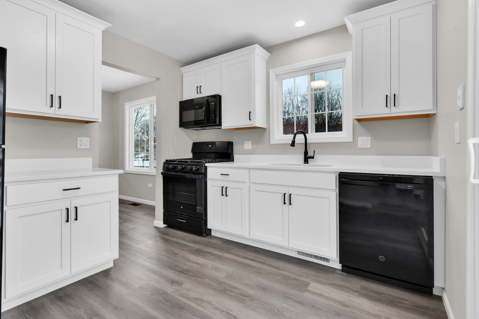 86 Silver Tree Circle Cary, IL 60013 - Photo 13 of 26 a kitchen with white cabinets and appliances