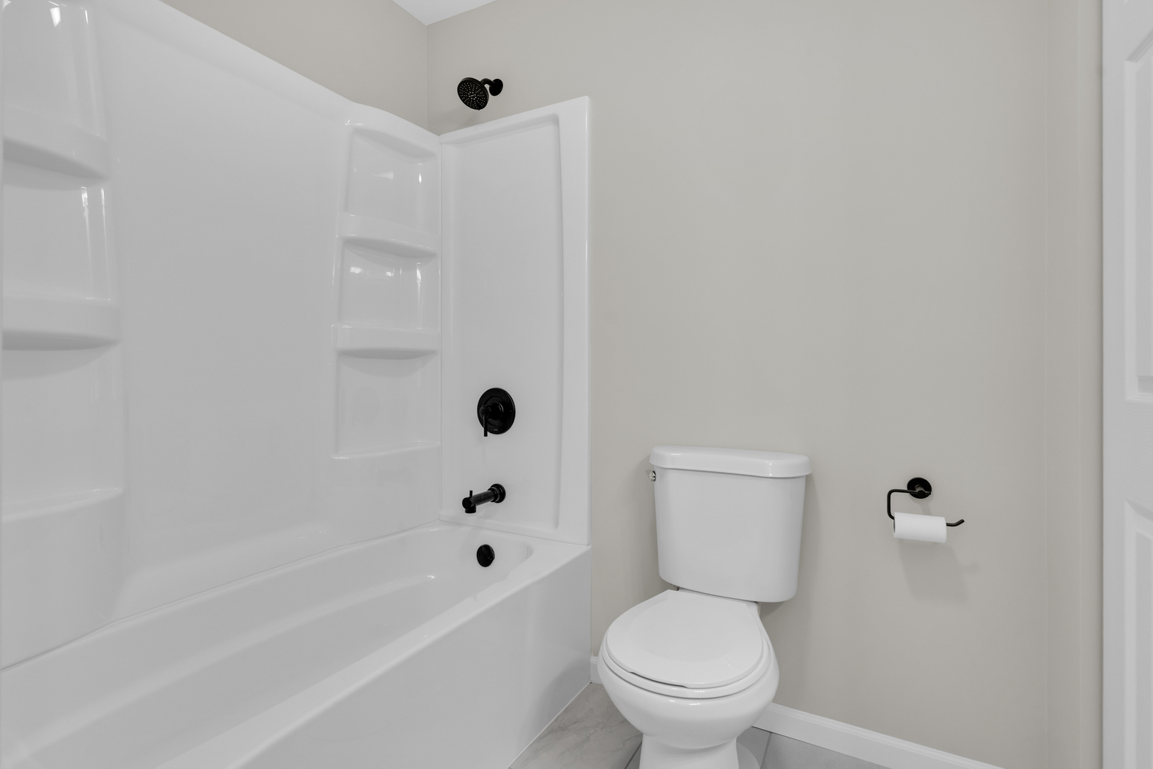 86 Silver Tree Circle Cary, IL 60013 - Photo 16 of 26 a white toilet sitting next to a bath tub