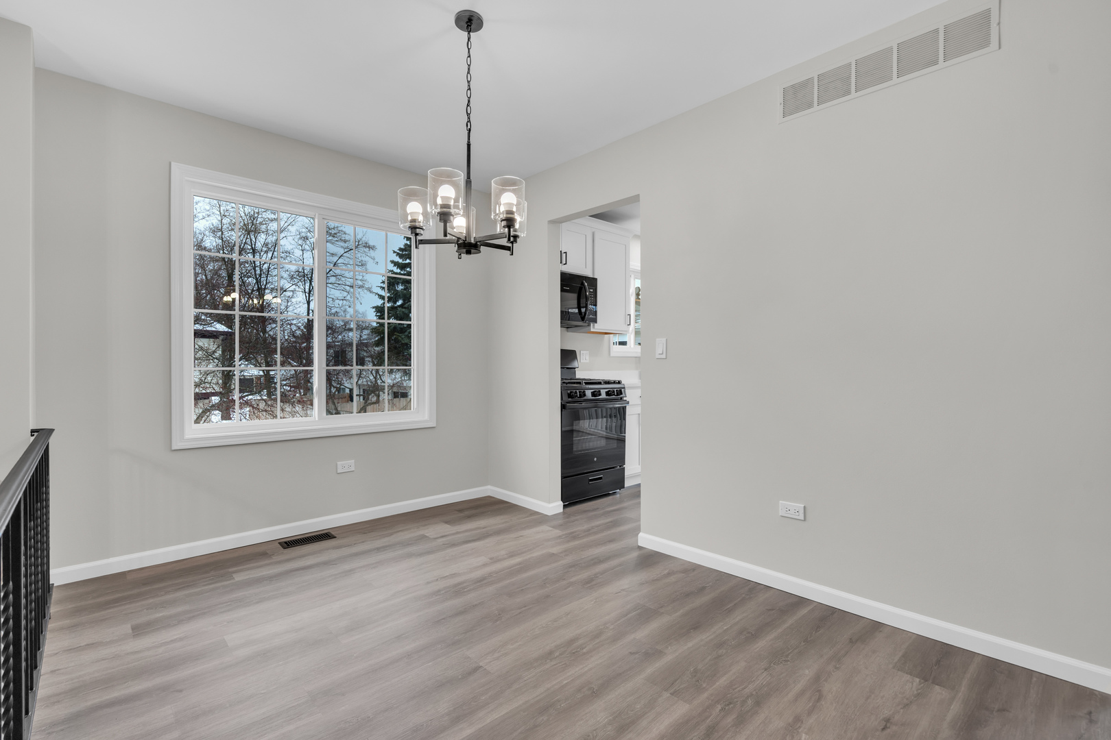 86 Silver Tree Circle Cary, IL 60013 - Photo 9 of 26 a view of livingroom with window wooden floor and chandelier