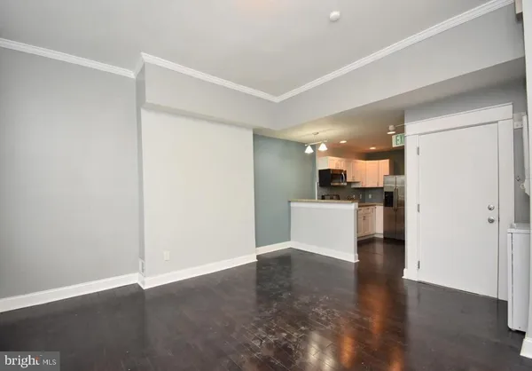 a view of a kitchen with a sink and a refrigerator