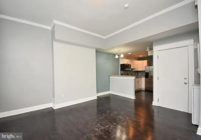 a view of a kitchen with a sink and a refrigerator