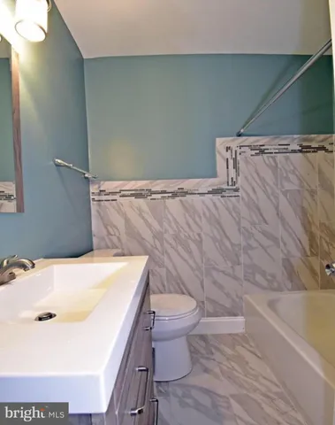 a bathroom with a sink a toilet and a bathtub
