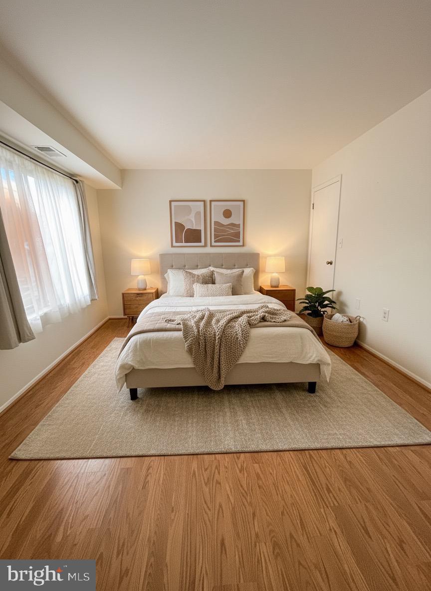 118 Mountain Road, Unit 1A Glen Burnie, MD 21060 - Photo 15 of 16 a bedroom with a bed and a night stand