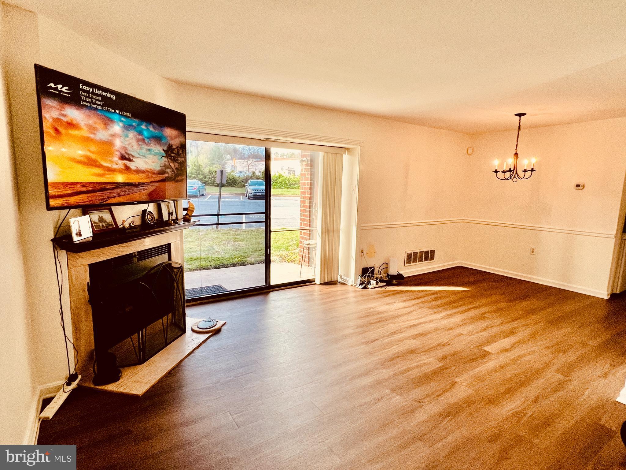 118 Mountain Road, Unit 1A Glen Burnie, MD 21060 - Photo 3 of 16 a view of empty room with wooden floor and fireplace