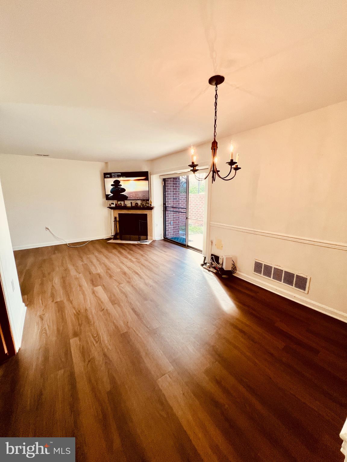 118 Mountain Road, Unit 1A Glen Burnie, MD 21060 - Photo 5 of 16 a view of a room with wooden floor fireplace and window