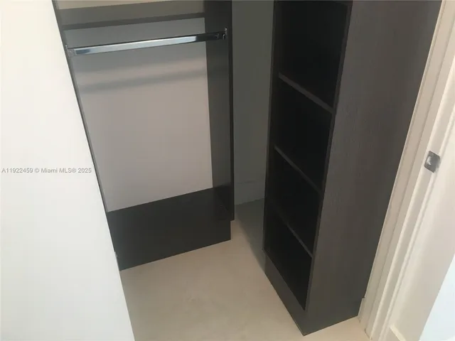 a view of a room with wooden floor and windows