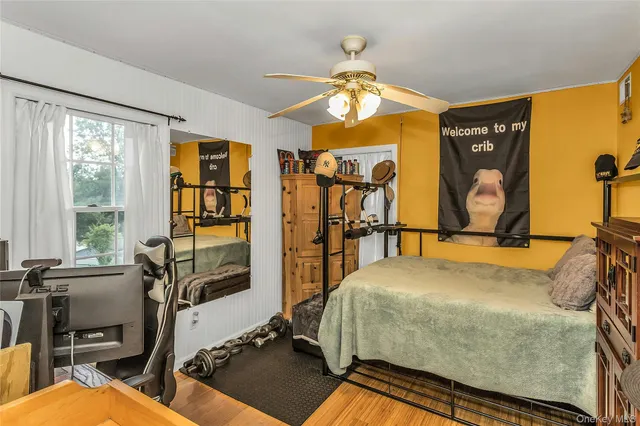 a spacious bedroom with a bed and a chandelier