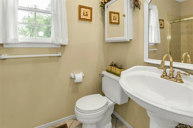 a bedroom with a bed and a flat tv screen on dresser
