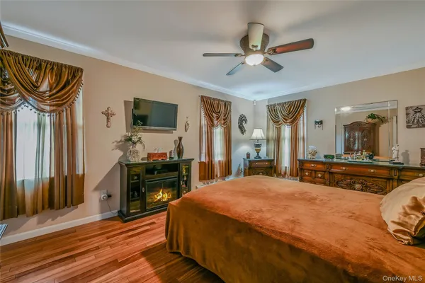 a spacious bedroom with a bed and a chandelier