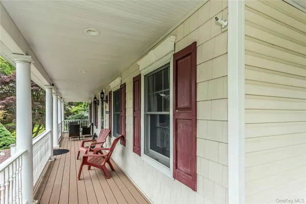 a balcony with chairs and table