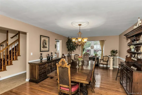 a view of a dining room with furniture wooden floor and chandelier