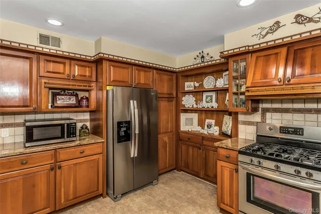a bathroom with a granite countertop sink mirror and shower