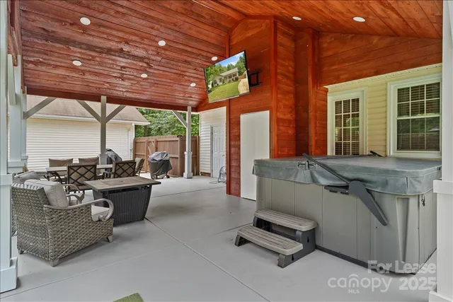a living room with patio furniture and a wooden floor