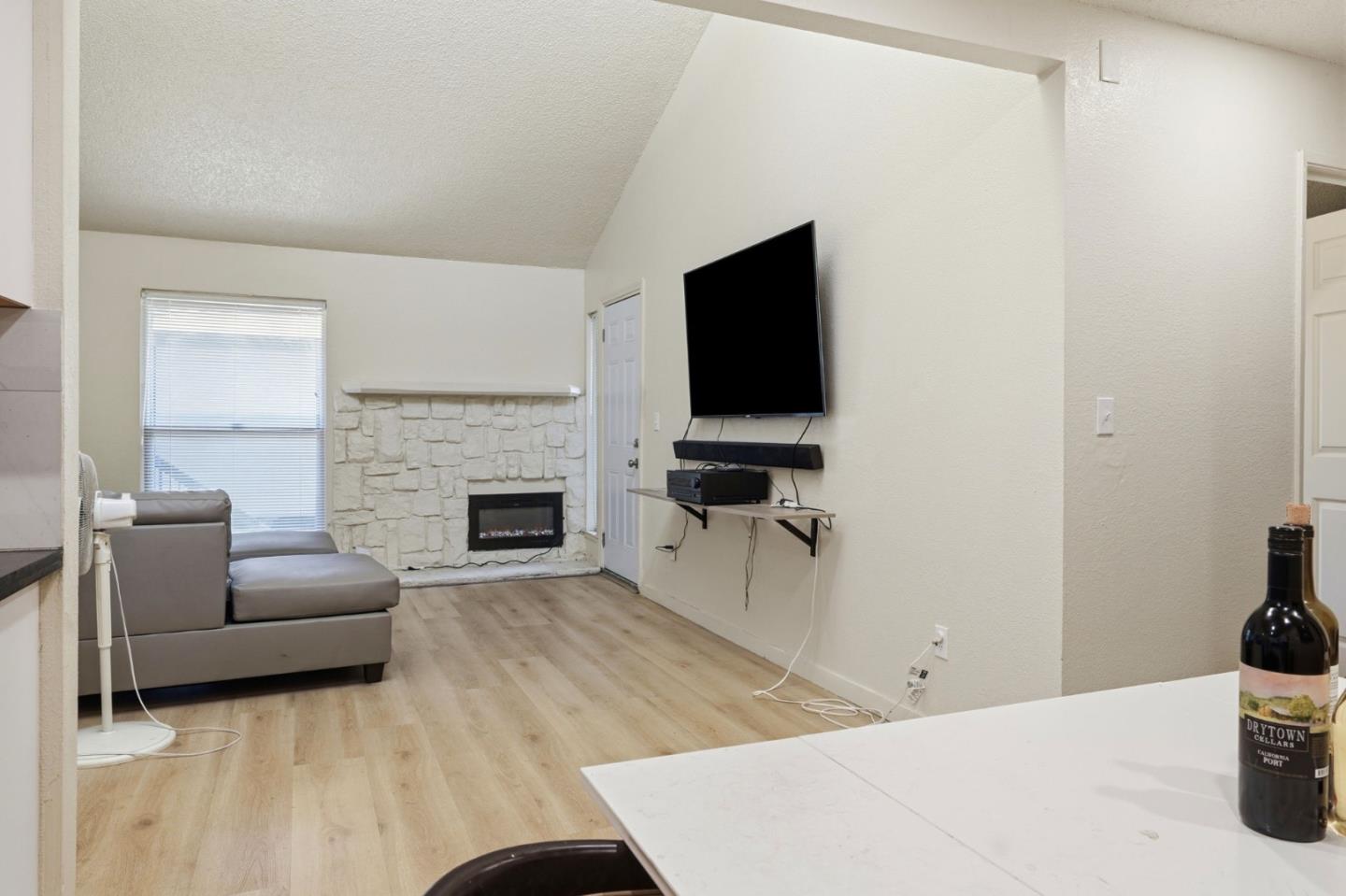 7283 Florin Road, Unit 8 Sacramento, CA 95828 - Photo 11 of 35 a living room with furniture a fireplace and a flat screen tv