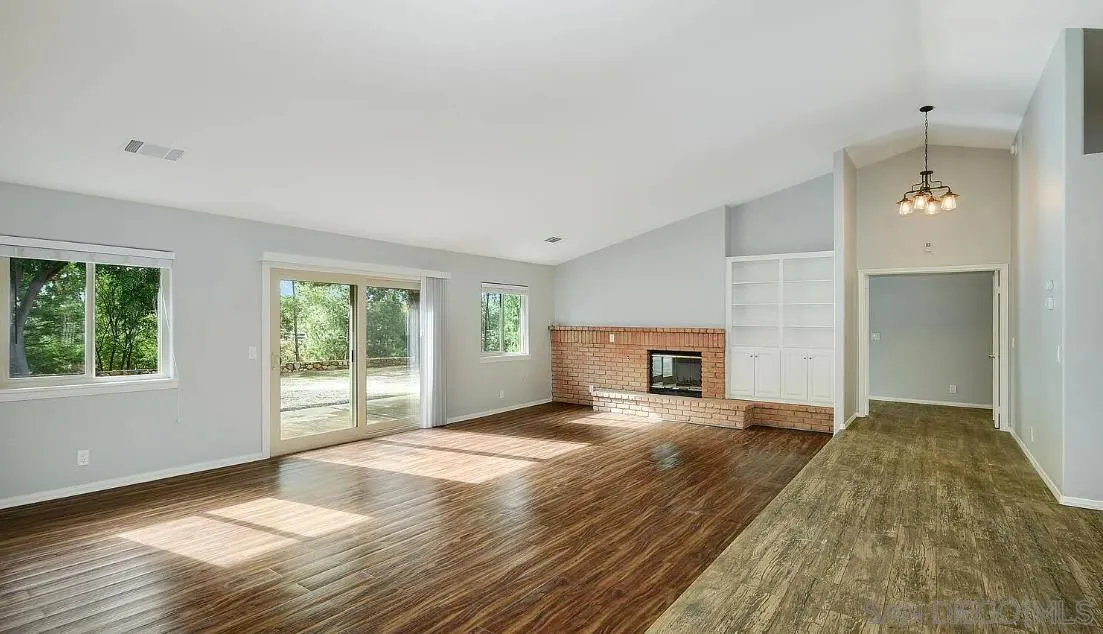 14525 Millards Ranch Lane Poway, CA 92064 - Photo 7 of 29 a view of a livingroom with wooden floor and a fireplace