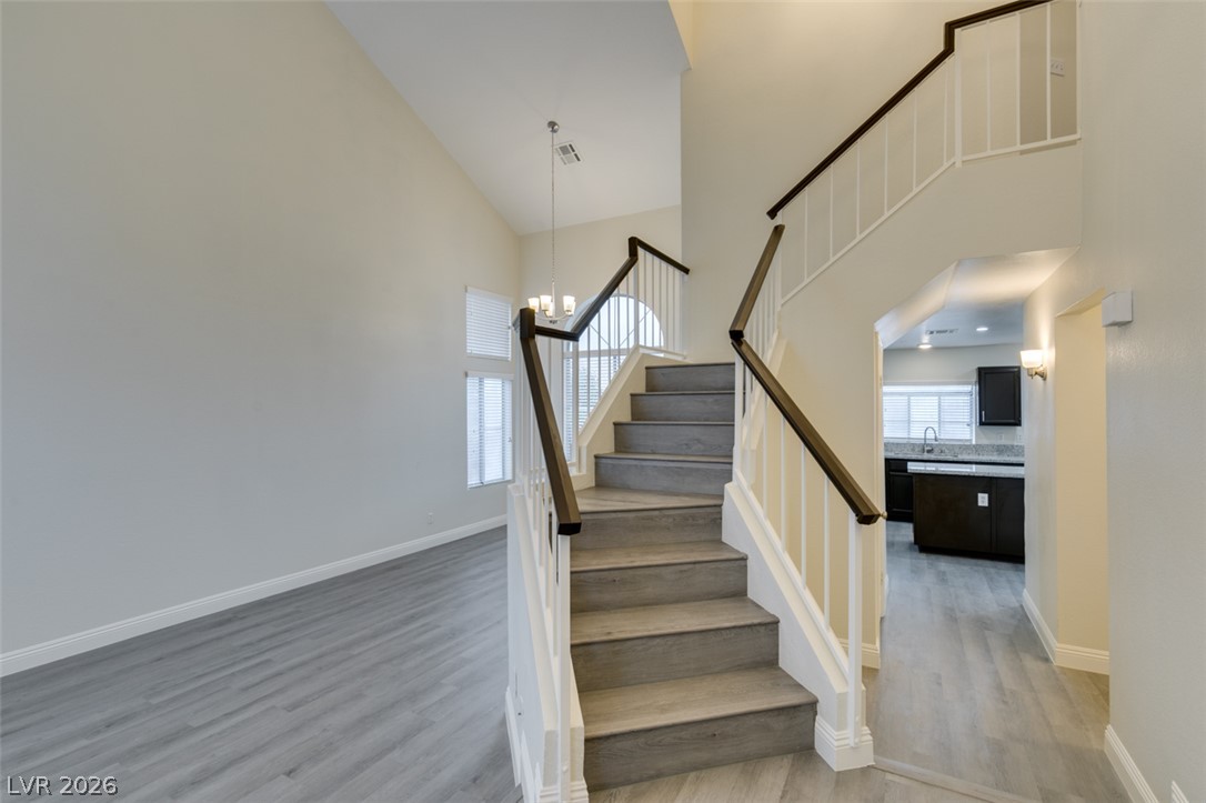 1738 Toltec Circle Henderson, NV 89014 - Photo 11 of 46 A grand, multi-level stairway with elegant railings leads to sun-filled upper floors.