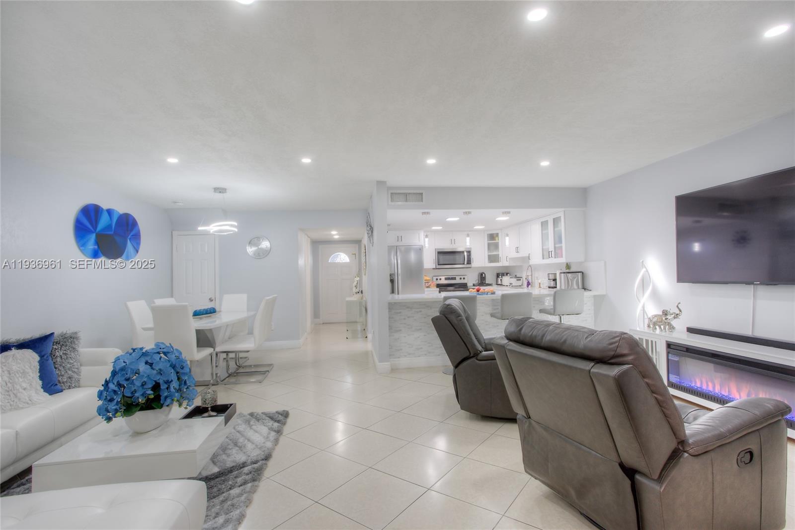 1925 West 72nd Street Hialeah, FL 33014 - Photo 3 of 15 a living room with furniture and a view of kitchen
