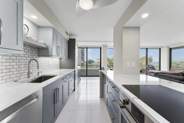 a kitchen with stainless steel appliances granite countertop a sink stove and cabinets