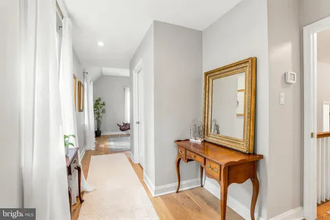 a view of a hallway with a furniture and a mirror