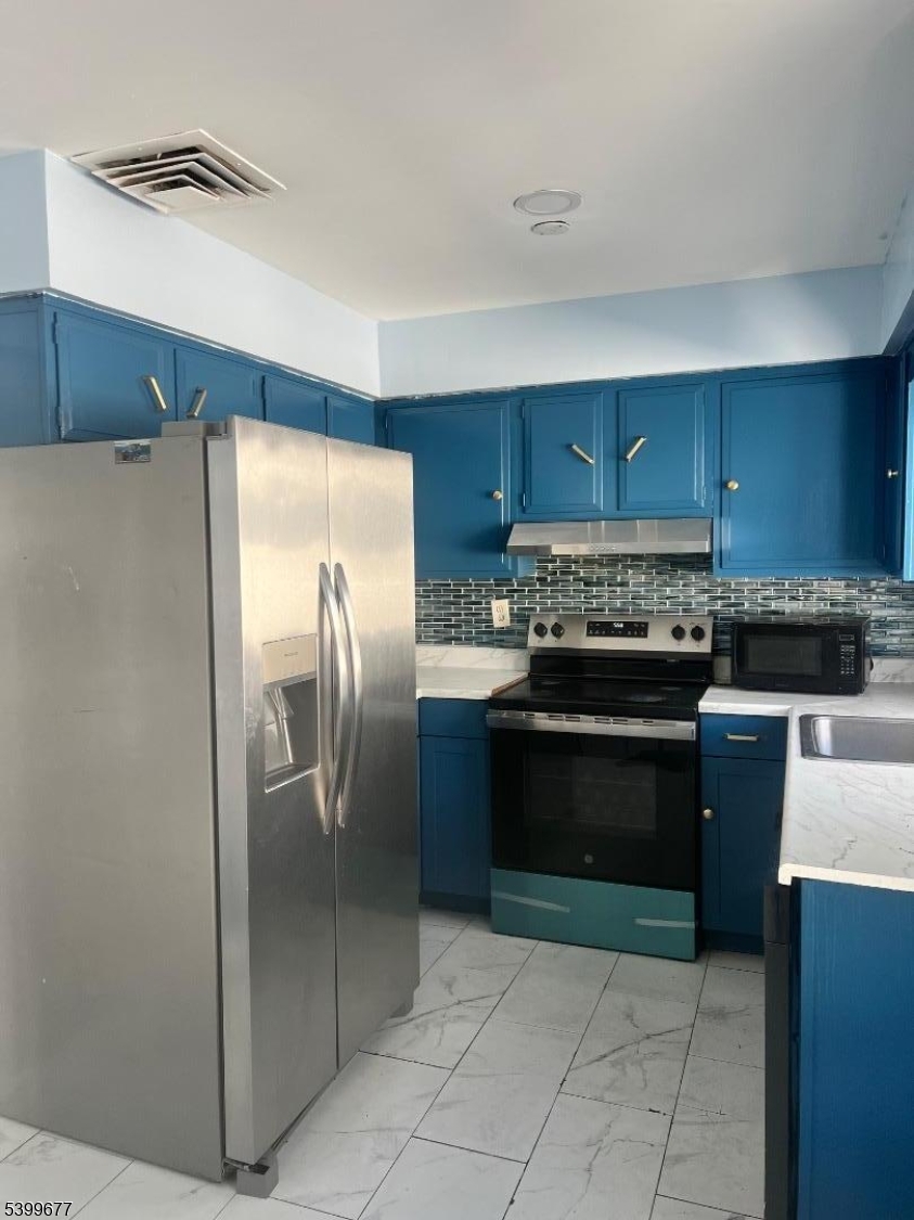 304 Concord Avenue Union, NJ 07083 - Photo 2 of 7 a kitchen with stainless steel appliances granite countertop a refrigerator and a stove