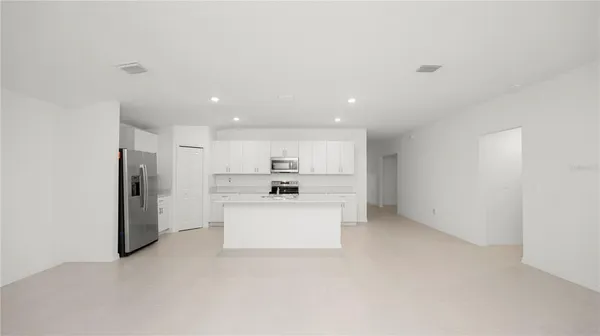 a view of a kitchen with refrigerator sink and stove