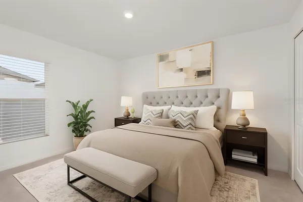 a bedroom with a bed and a potted plant