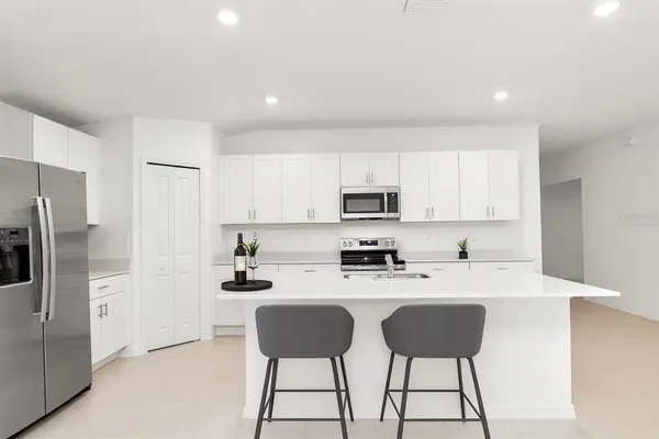 a kitchen with stainless steel appliances a refrigerator stove microwave and cabinets