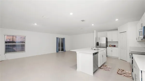 a kitchen with appliances and cabinets
