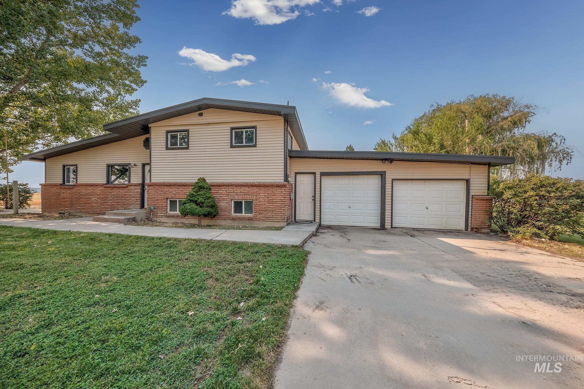 1741 Cove Road Weiser, ID 83672 - Photo 4 of 46 Split-level home featuring a brick and vinyl exterior with a modern pitched roofline
