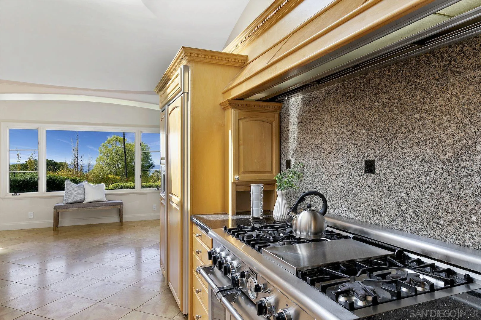 9660 Blackgold Road La Jolla, CA 92037 - Photo 15 of 32 a kitchen with stainless steel appliances granite countertop a stove and a refrigerator