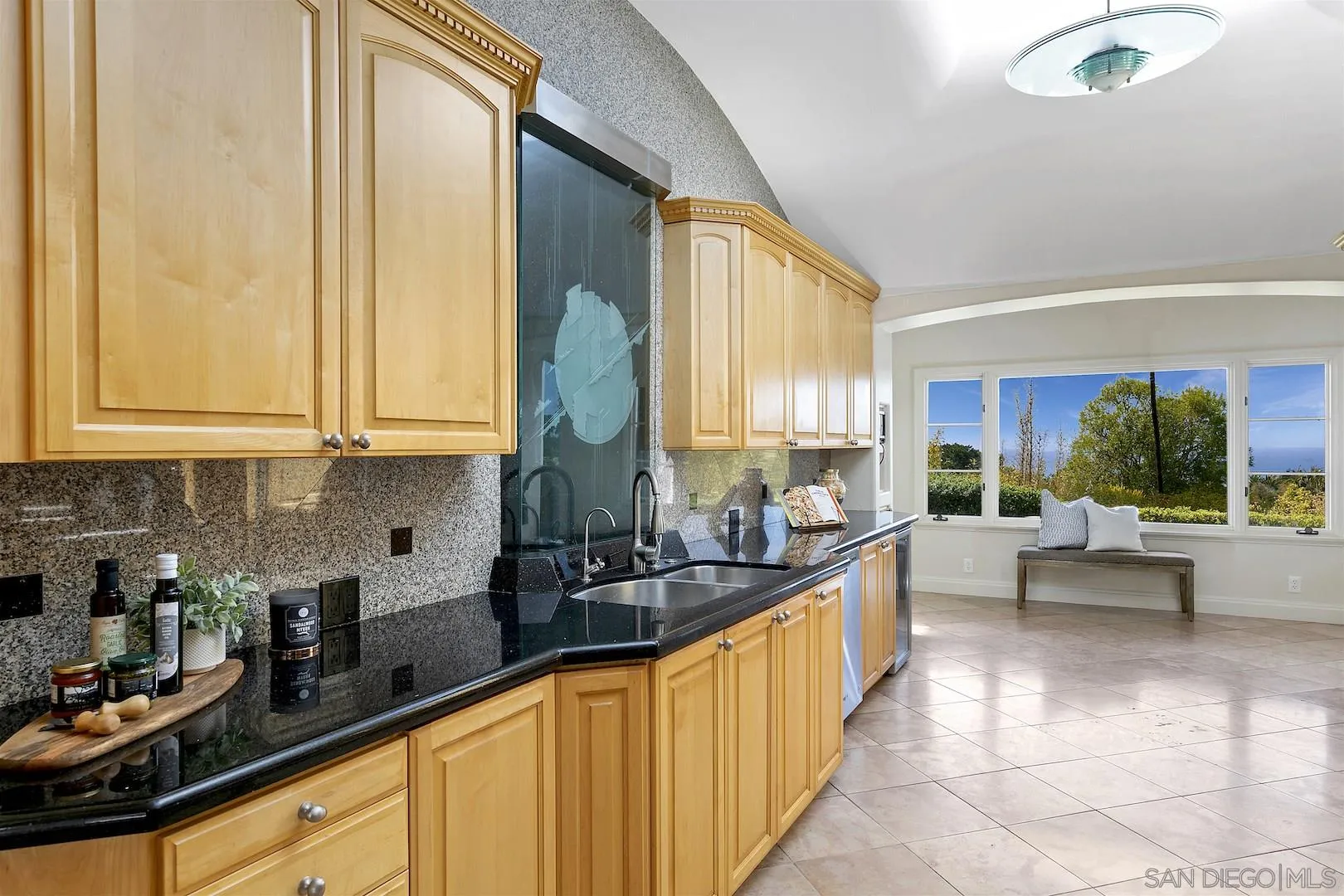 9660 Blackgold Road La Jolla, CA 92037 - Photo 16 of 32 a view of a kitchen with kitchen island granite countertop a large window and a counter space
